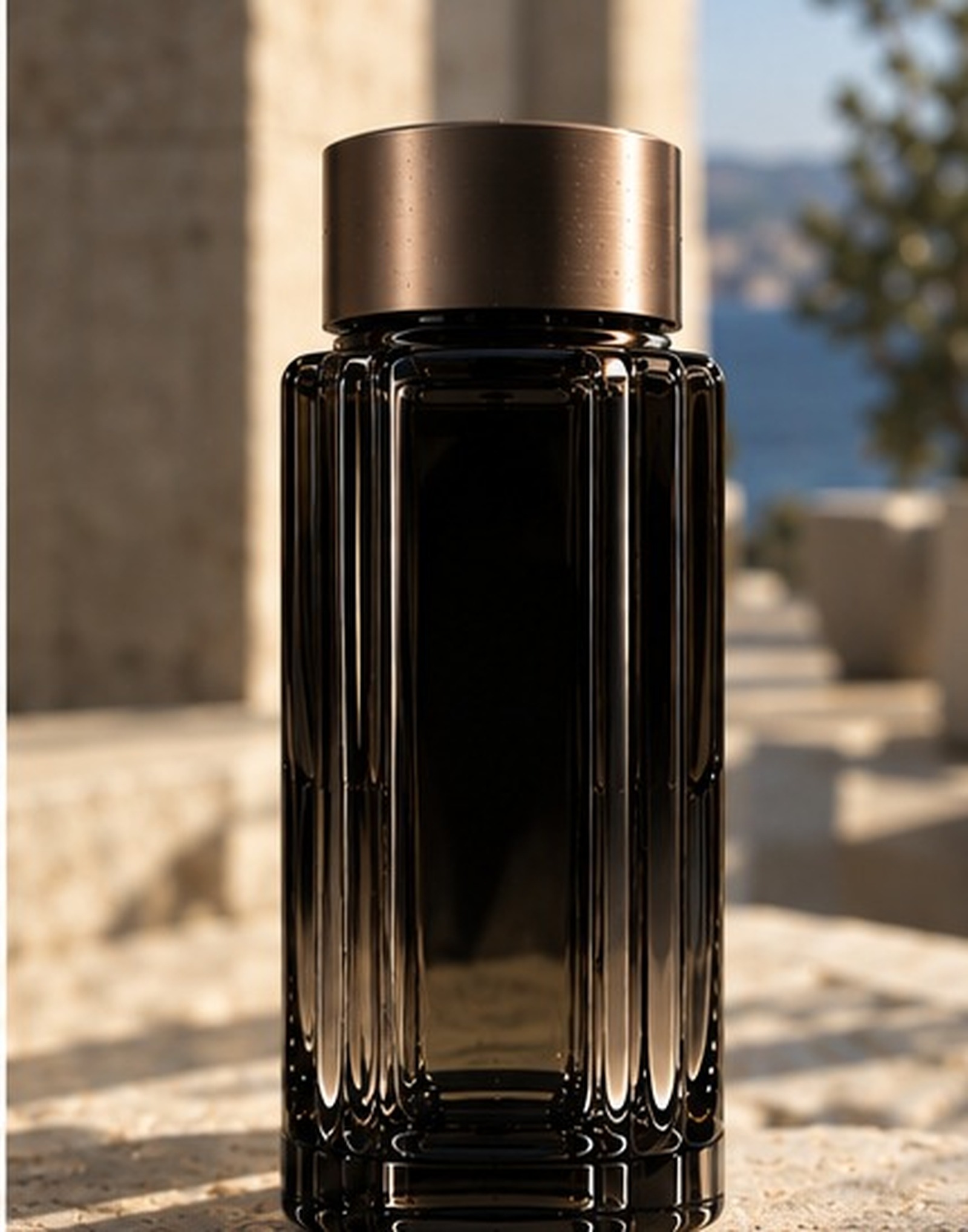 ÉVREN eau de parfum standing on stone above the sea at dusk